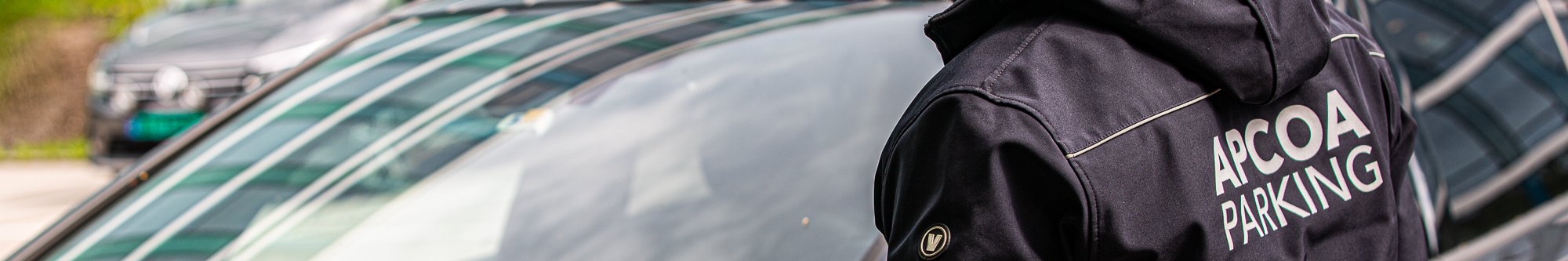 Control officer issues a control sanction on a car in a parking area 